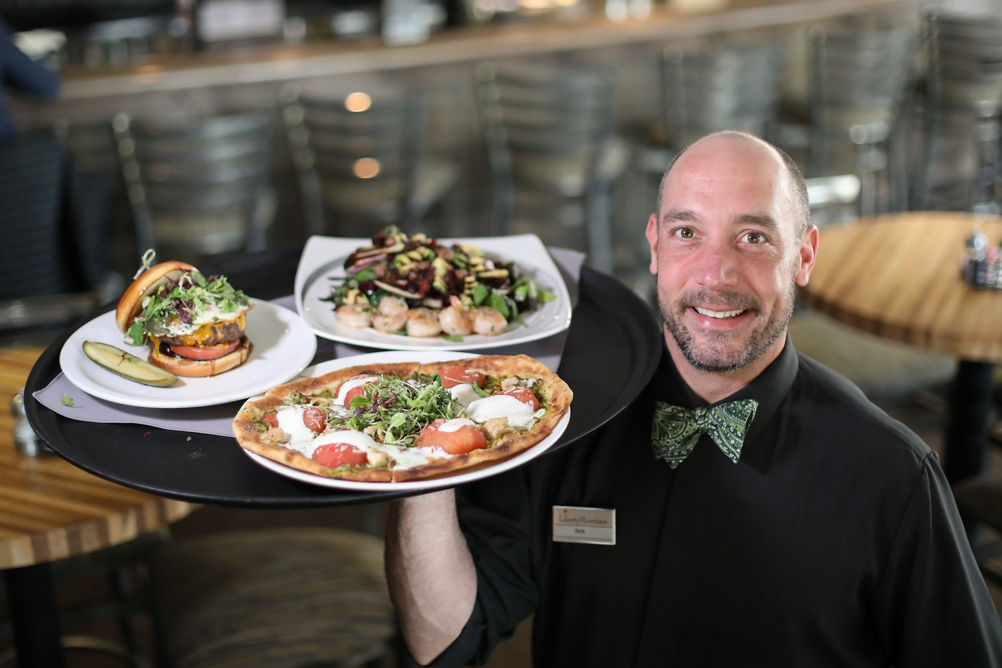 Waiter Carries Dinner to Table at Liberty Mountain