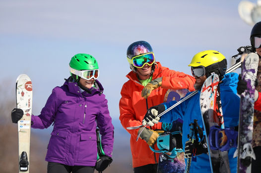 Group of Skiers and Riders Laugh Together at Liberty Mountain