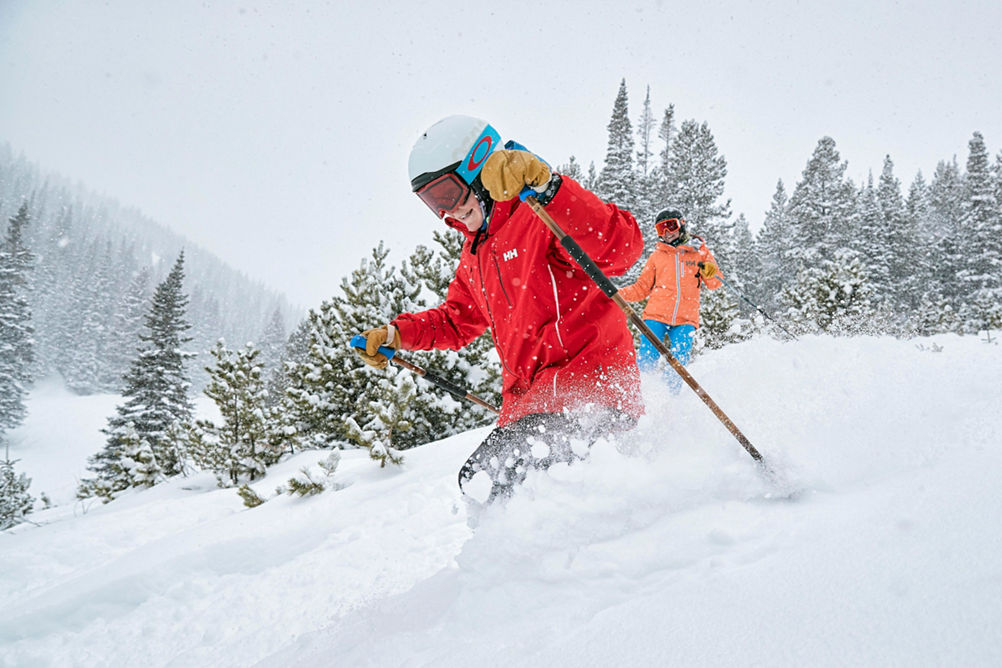Son and mom ski through powder on Peak 8 at Breckenridge