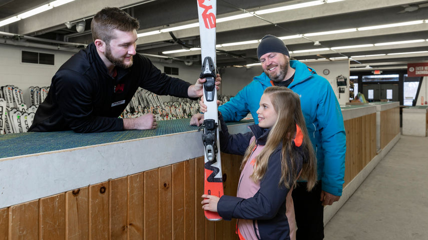 Staff Helping Family with Ski Rentals at Wilmot Mountain