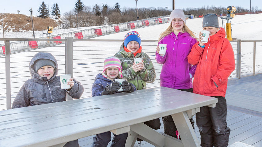 Family enjoys hot beverages after tubing at Wilmot 