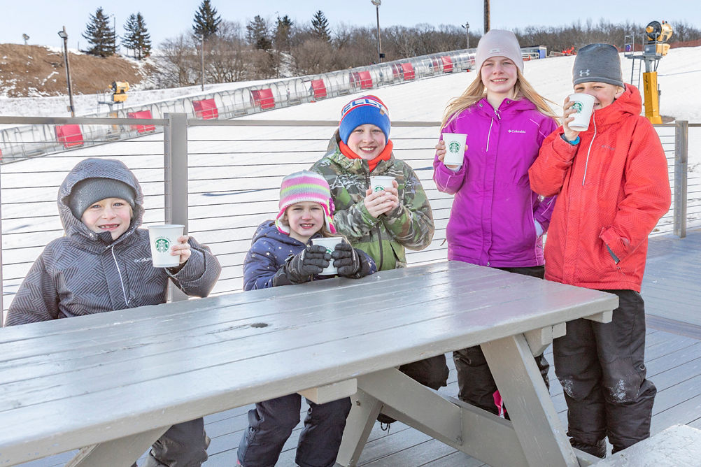Family enjoys hot beverages after tubing at Wilmot 