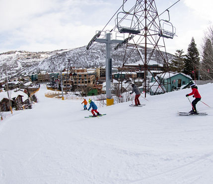 Family skiing into town at Park City