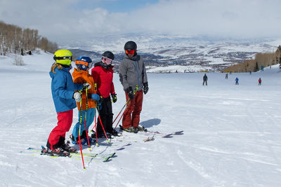 Family stopped on a ski run in Park City