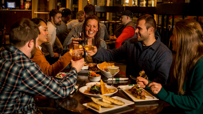 Friends enjoying dinner in Whistler Blackcomb.