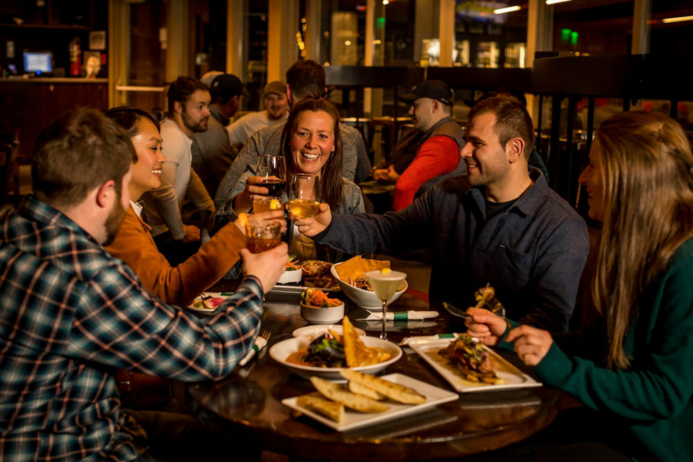 Friends enjoying dinner in Whistler Blackcomb.
