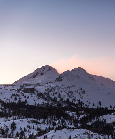 Family skiing at twilight in Kirkwood, CA.