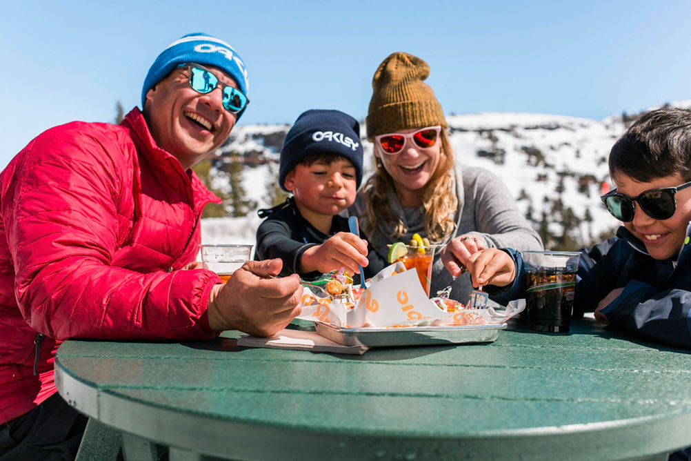 Family Enjoying Food and Drinks in the Sunshine in Kirkwood, CA.