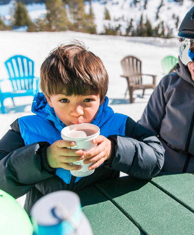 Boy drinking hot chocolate in Kirkwood, CA.