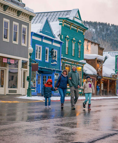 Family walking in village in Crested Butte, CO