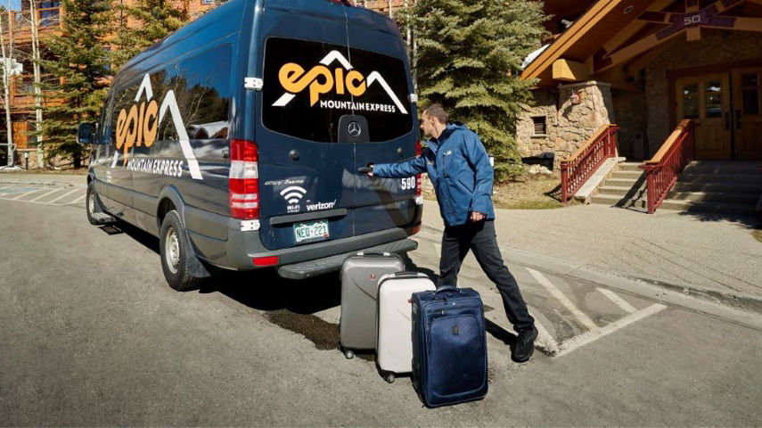 Driver Loads Luggage Into Epic Mountain Express Van