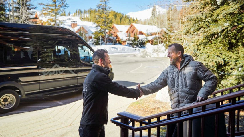 Driver for Epic Mountain Express Greets Passenger