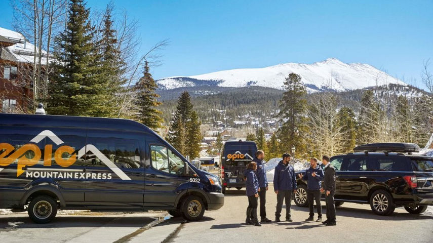 Epic Mountain Express Drivers Stand Near Vehicles