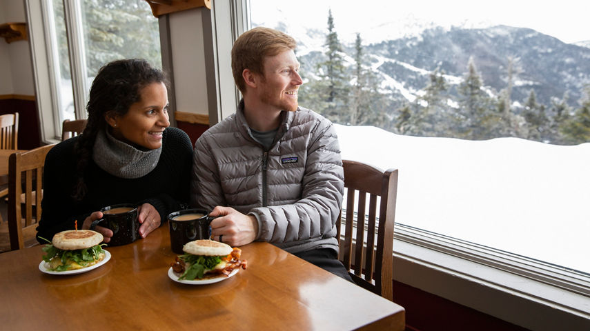 Couple eats lunch at an on-mountain restaurant in Stowe, VT.