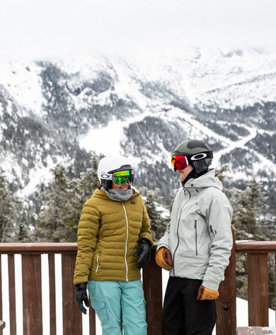 Couple enjoys the deck of an on-mountain restaurant in Stowe, VT.