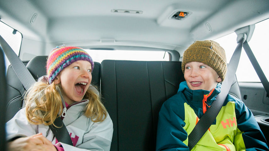 Family in GMC car in the snow in Kirkwood, CA.