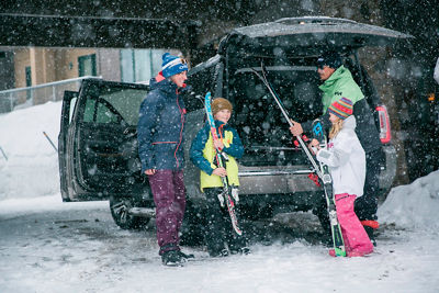 Family in GMC car in the snow in Kirkwood, CA.