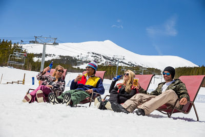 Friends drink beer at base area during Spring Finale at Breck