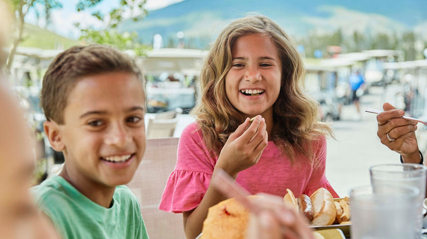 A family eats lunch after golfing at the River Course Grill in Keystone, CO.