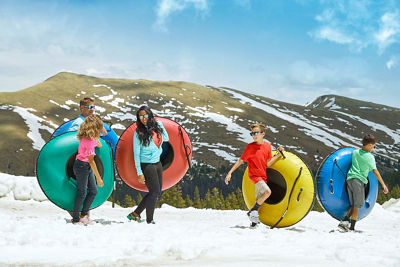 Family enjoys summer snow tubing in Keystone, CO.