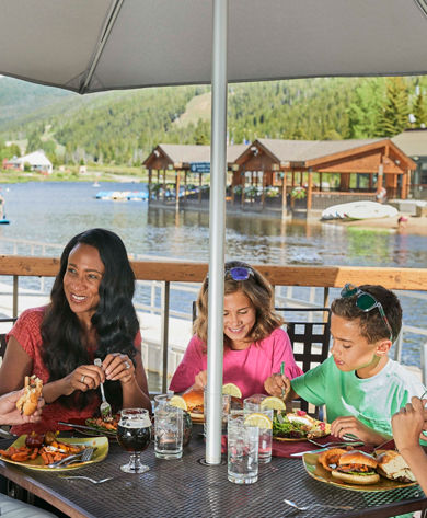 Family eats lunch at Edgewater Cafe in Lakeside Village at Keystone, CO.