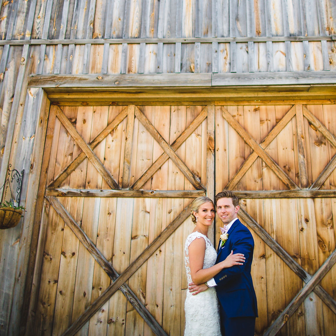 Couple Poses for Wedding Photo in Front of Bluebird Express Barn at Mount Snow