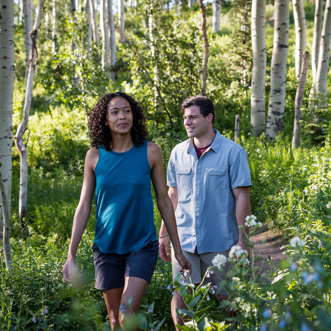 A couple walks along a nature path during summer at Park City