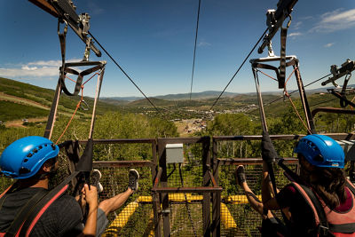 Friends go ziplining during a summer day at Park City