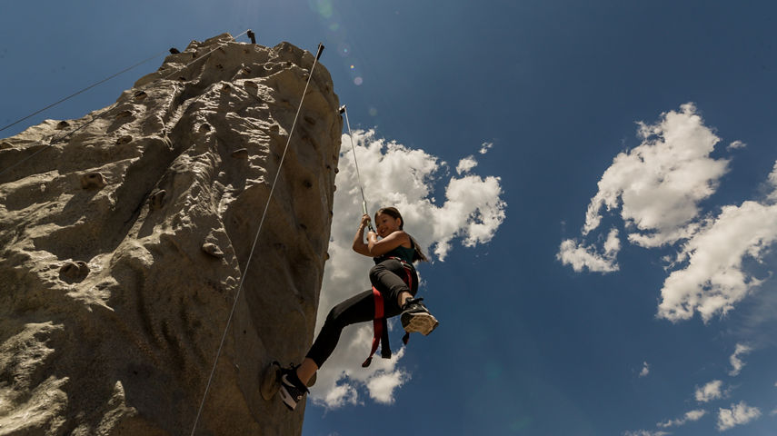 A woman goes climbing on a bright summer afternoon at Park City