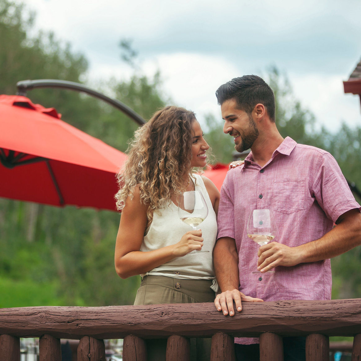 Couple Enjoys Wine Together on Beano's Cabin Deck in Beaver Creek, CO