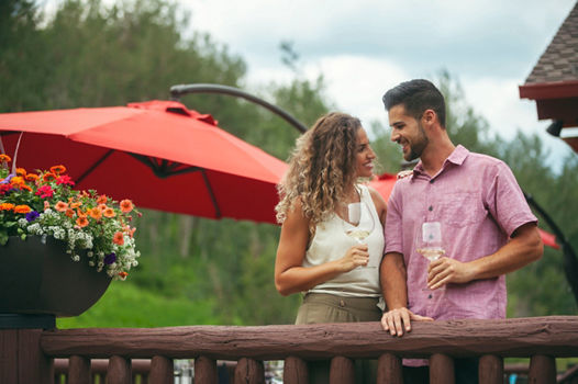Couple Enjoys Wine Together on Beano's Cabin Deck in Beaver Creek, CO