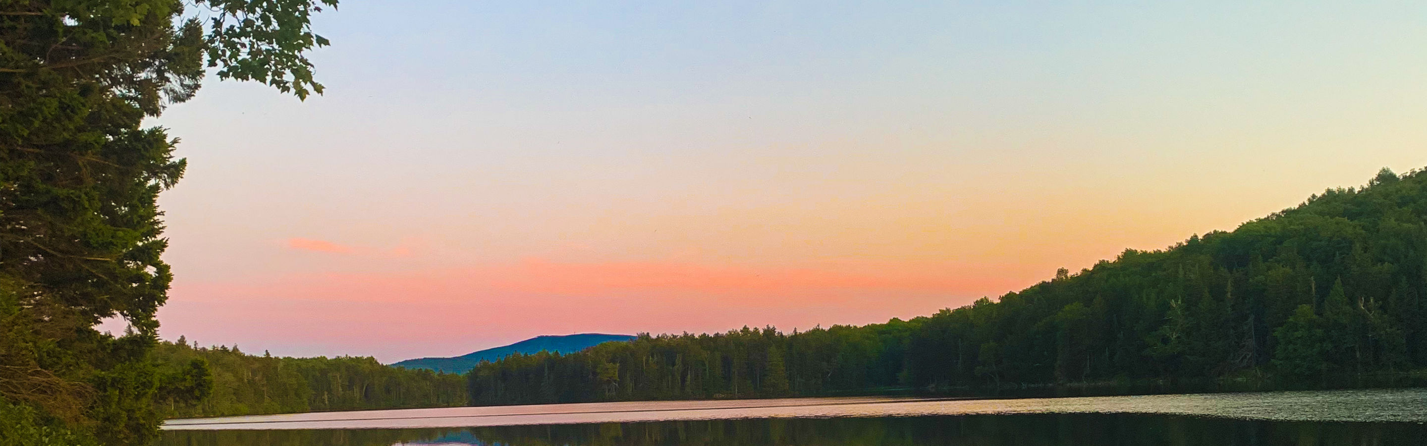 Canoe on Lake at Sunrise near Mount Snow