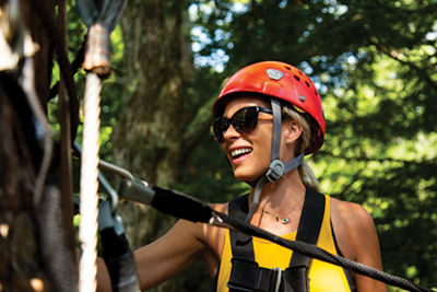 Woman Smiles in Ziplining Safety Gear at Hunter Mountain