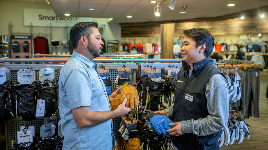 Man shopping for gloves at Epic Mountain Gear