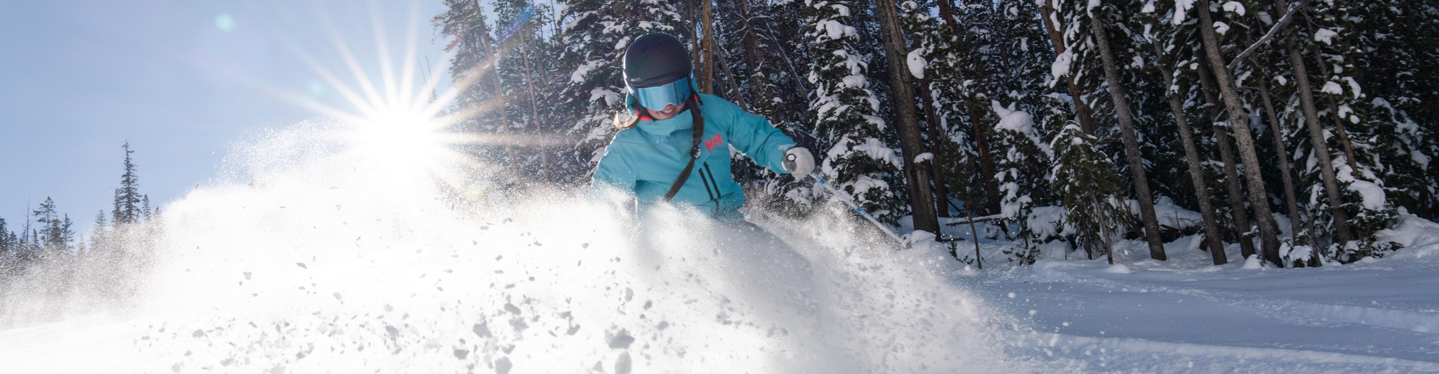 Single female skiier on North Peak on a blue sky day at Keystone, CO