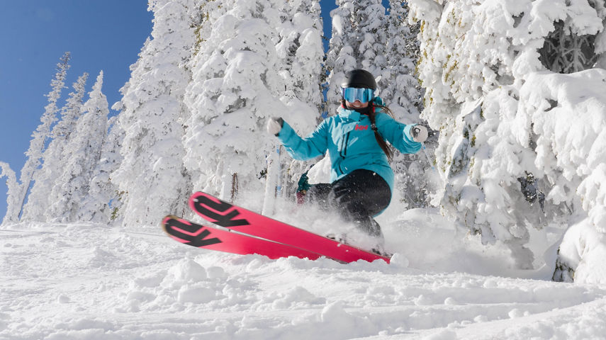 Single female skiier on North Peak on a blue sky day at Keystone, CO