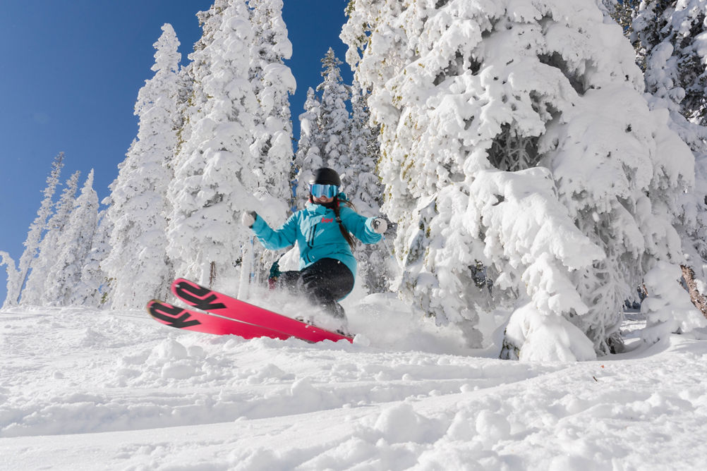Single female skiier on North Peak on a blue sky day at Keystone, CO