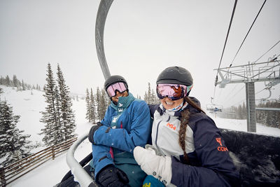 Some friends celebrate a powder day on chairlift at Breck