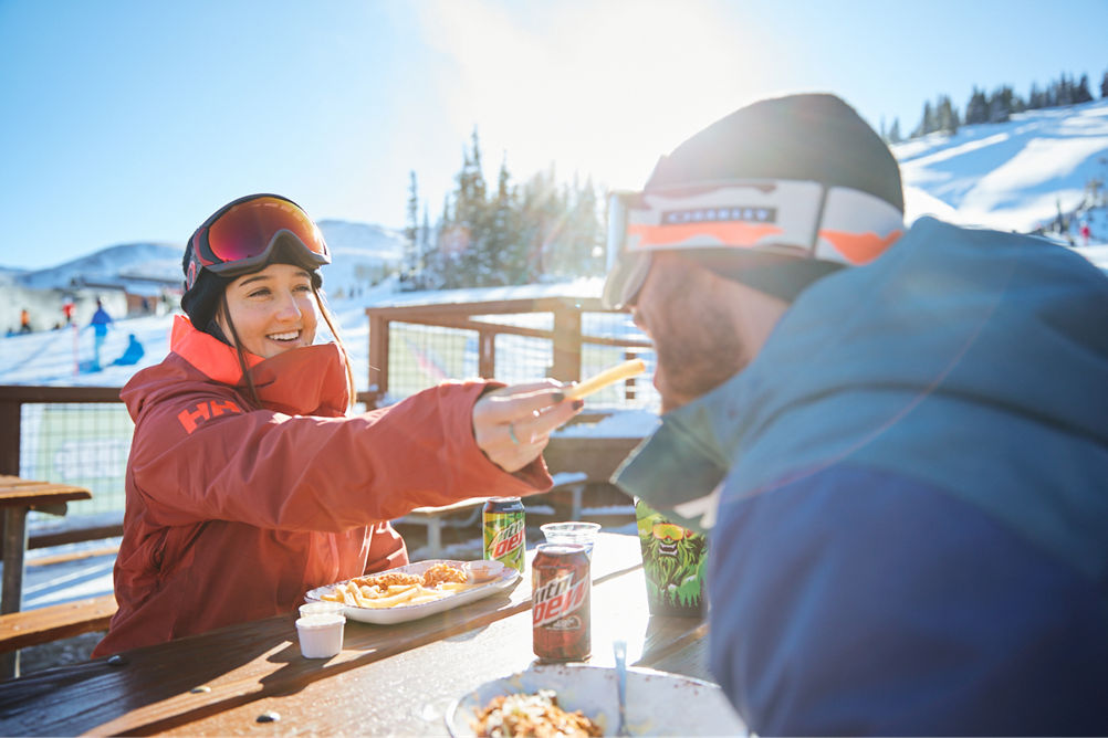 A couple eats lunch outside at Breck