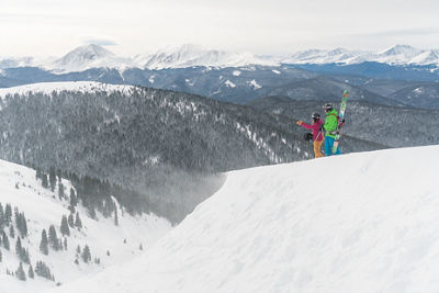 Two friends hike to Erickson Bowl at Keystone, CO.
