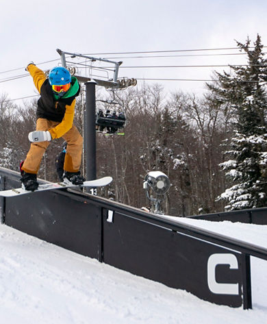 Snowboarder Hits Rail at Carinthia Terrain Park at Mount Snow