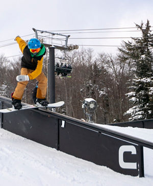 Snowboarder Hits Rail at Carinthia Terrain Park at Mount Snow