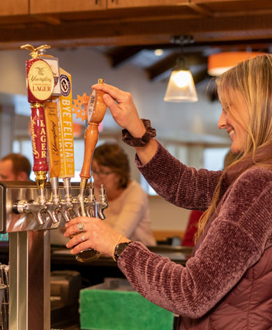 Bartender Pours Draft Beer at Bar at Whitetail