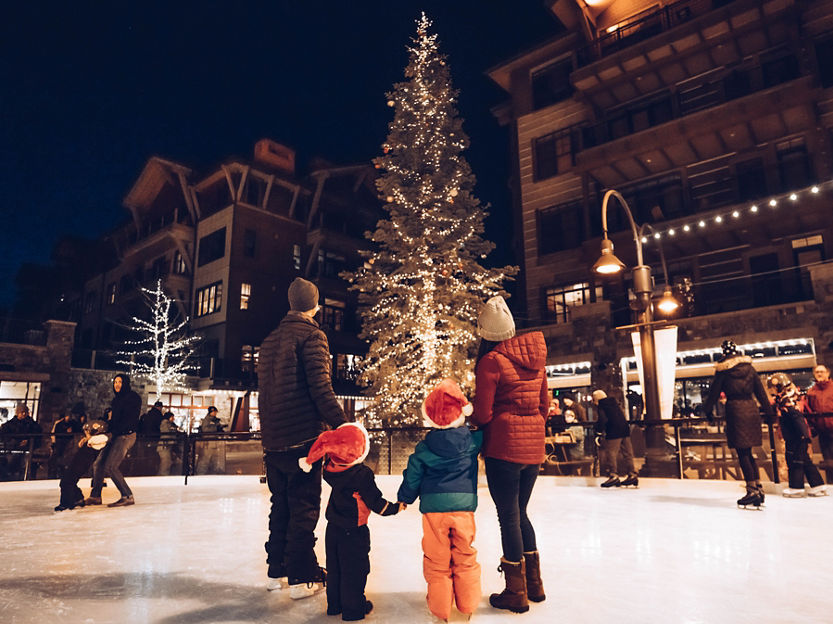 Family Looks up at the Noel Nights Christmas Tree in The Village at Northstar