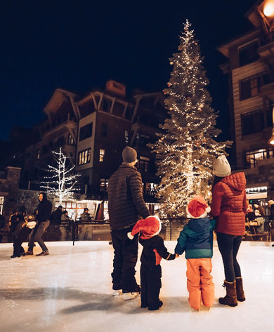 Family Looks up at the Noel Nights Christmas Tree in The Village at Northstar