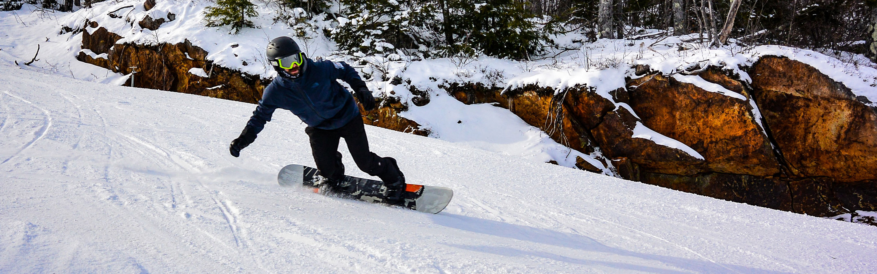 Snowboarder Makes Turns on Groomed Runs at Crotched Mountain
