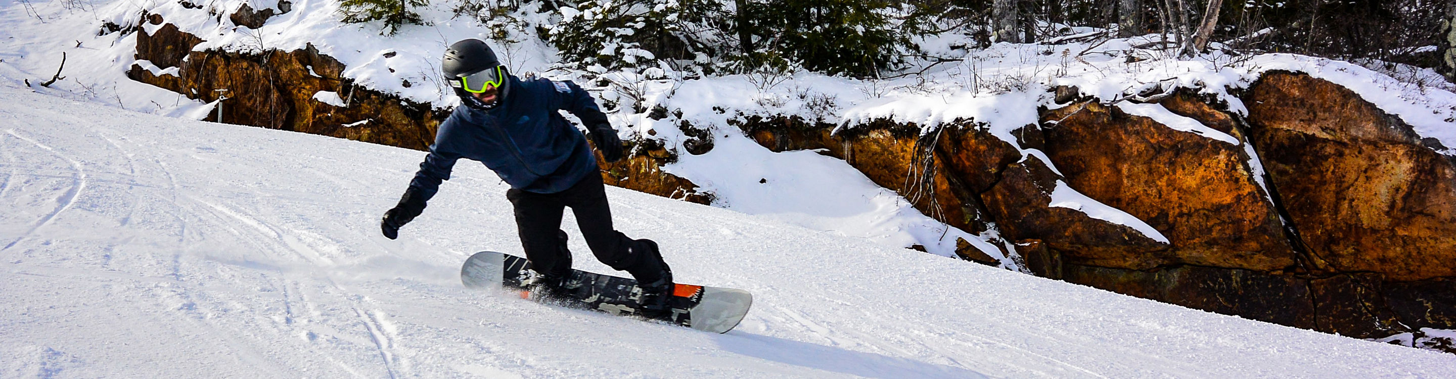 Snowboarder Makes Turns on Groomed Runs at Crotched Mountain
