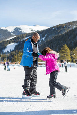 Family ice skates on the Keystone Lake in Keystone, CO.
