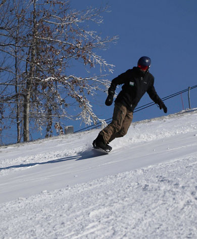 Snowboarder Rides Downhill at Hidden Valley