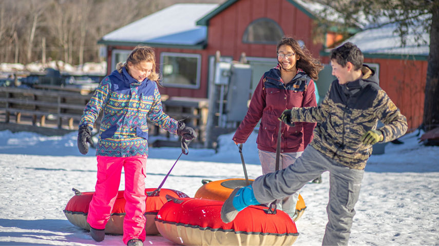 Kids Carry Tubs to Tubing Hill